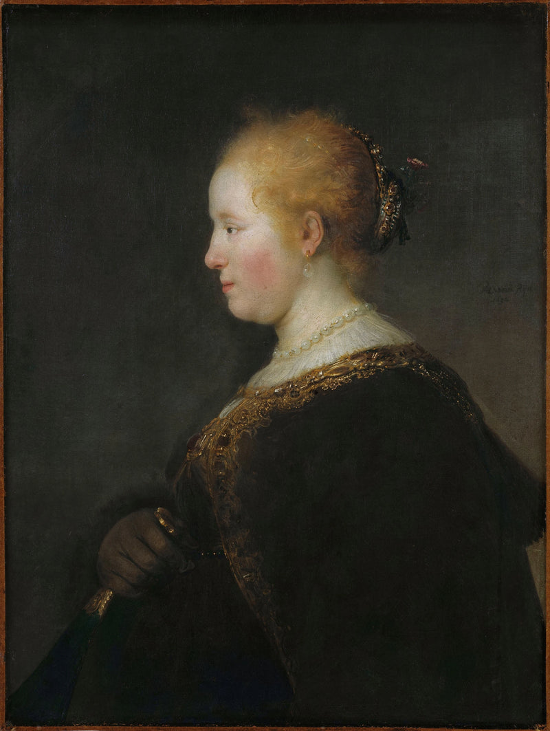 Dam som håller en fläkt - Rembrandt